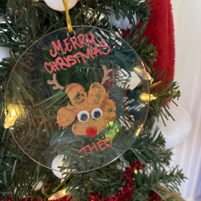 A paw print Christmas ornament made at Pawsh Park